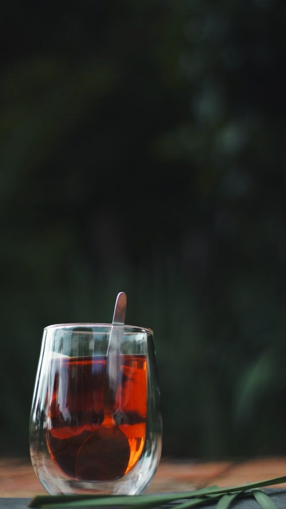 clear drinking glass with red rooibos