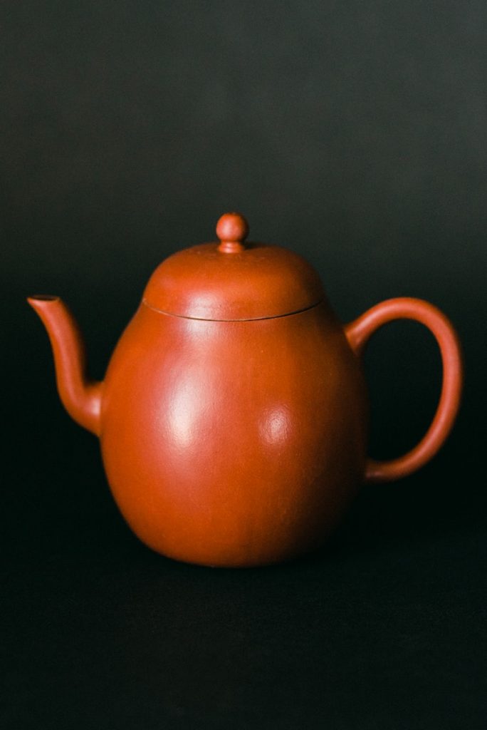 brown teapot on gray surface