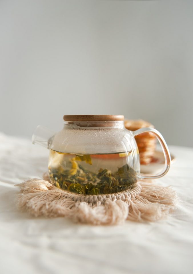 herbal tea brewing in clear teapot