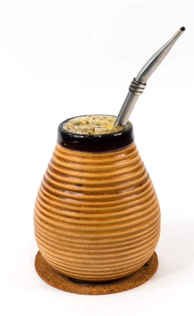 brown and black ceramic jar with yerba brewing
