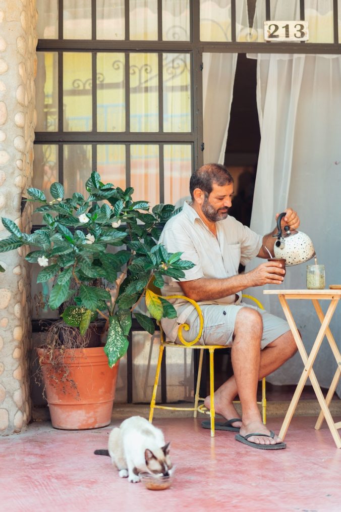 A Man Sitting at the Table with a cup of Yerba Mate